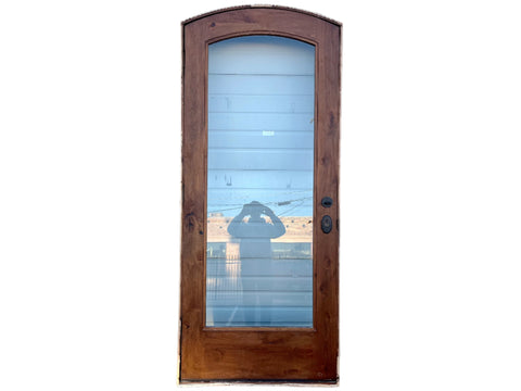 Reclaimed interior door, arched top, solid wood with glass center, with jamb, hinges and knob. 36" wide, 95" tall, 6.5" deep. Right opening. 