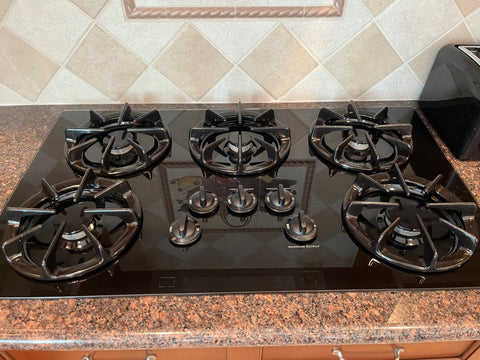 General Electric, 36", 5 burner, gas cooktop installed into a countertop. 