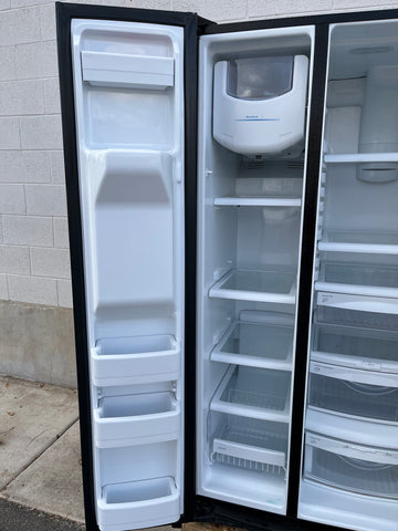 Interior of freezer in GE DSE25JGHBCBB with adjustable shelves and bins. 