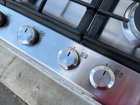 Detail of knobs on 30" KitchenAid gas stove top. 