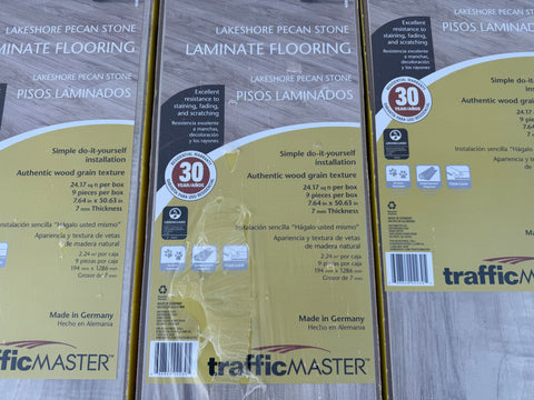 Label detail of new light gray, woodgrain texture flooring. 