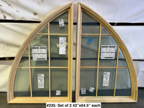 Set of new, arched, wood-framed Pella windows with grid pattern. 