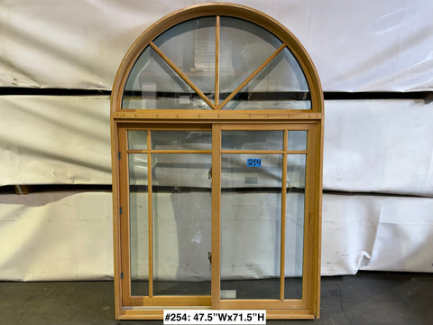 Good, used Marvin single slider window with wood frame, grid and arch top. 
