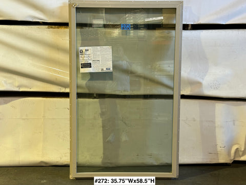 Fixed 2 pane exterior window with beige vinyl frame & nail fin. 