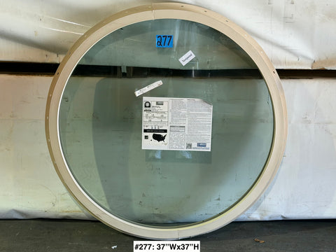 New 37" round, dual pane window in beige vinyl frame with nail fin. 