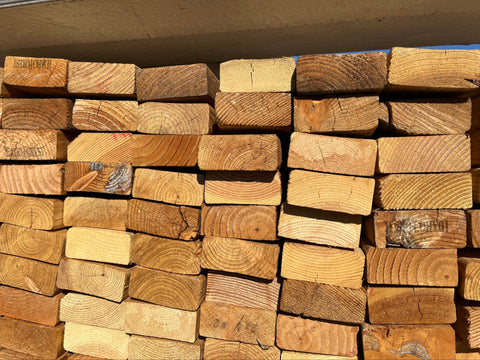 End detail of stack of new 2"x4"x4' lumber. 