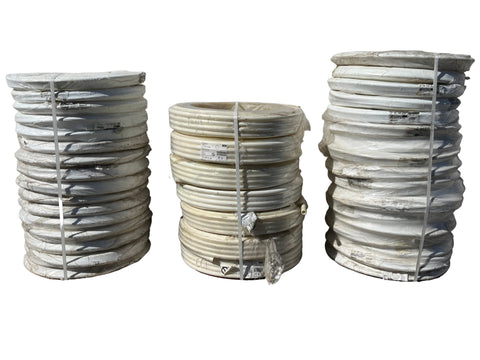 Multiple 100' coils of 3/4" and 1" PEX plumbing pipe. 
