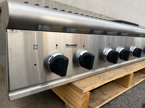 Stainless steel Thermador Professional kitchen range with black control knobs. 