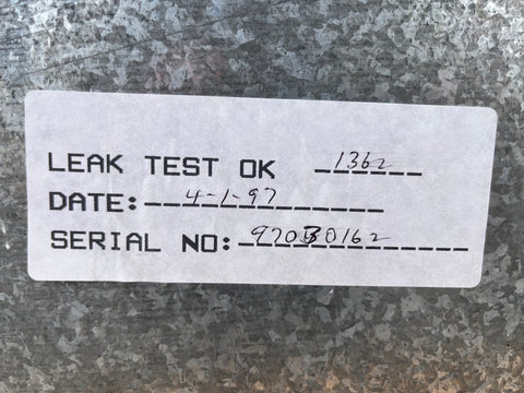 Label with 'LEAK TEST OK' and date on Thermador gas cooktop. 