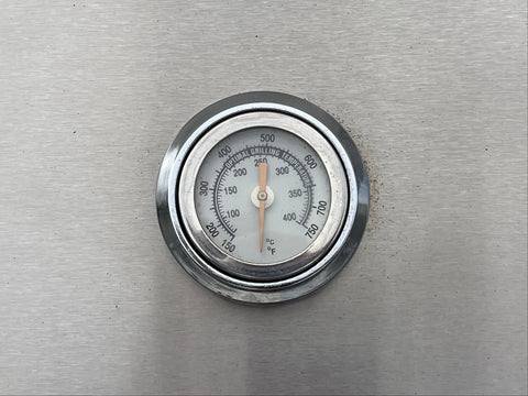 Hermetically sealed numerical thermometer on exterior of grill canopy. 