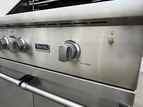 Detail of control knobs & light switch on Viking grill. 