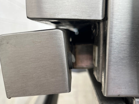 Detail of missing stay on Viking grill pull-out drip tray. 