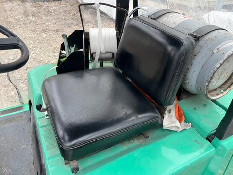 Seat and propane tank details on green Mitsubishi forklift. 