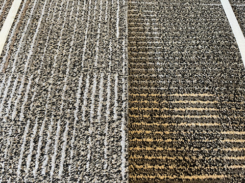 Close up of good, used, 20", 3/8" thick, commercial carpet squares in a black, gray, brown, yellow pattern.