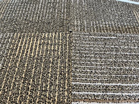 Several good, used, 20", 3/8" thick, commercial carpet tiles in a black, gray, brown, yellow pattern.