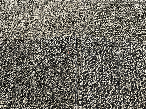 Close up of good, used, 20", 3/8" thick, commercial carpet squares in a moss green & black pattern. 