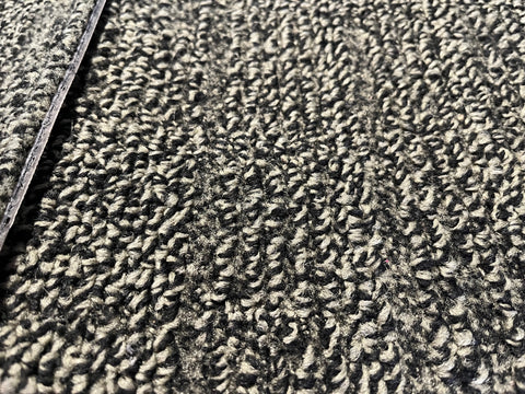 Close up of good, used, 20", 3/8" thick, commercial carpet tiles in a pattern of black & moss green.  