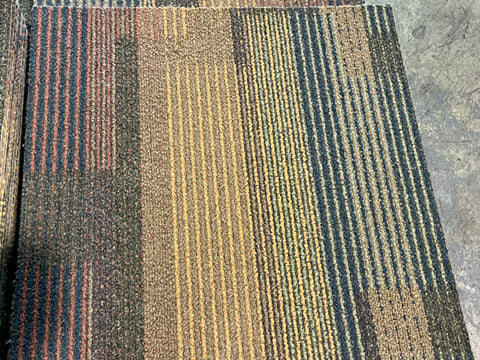 Overview of multicolor, 20"x20", used, commercial carpet square. 