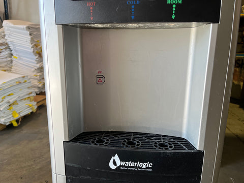 Detail of dispensing area in used WaterLogic WL270 dispenser. Fits cups up to 9" and features removable drip tray. 