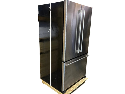 3/4 view of reclaimed Ikea French door refrigerator with stainless steel front and black sides. 