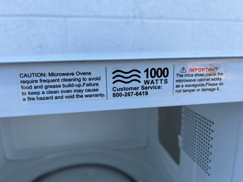 Close up of label on Hamilton Beach microwave oven displaying 1000 watts of power. 