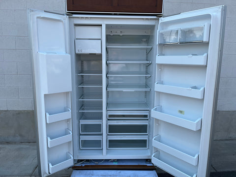 Overview of opened GE Monogram fridge/freezer with doors open, displaying multiple shelves, bins & drawers. 