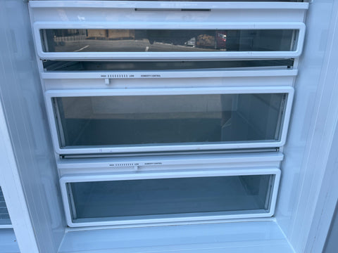 Interior view of GE Monogram built-in custom refrigerator showing dual humidity-controlled drawers and meat & cheese compartment. 