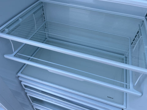 Interior view of G.E. built-in Monogram refrigerator showing adjustable spillproof shelves and unique, swing-down Quick Shelf. 