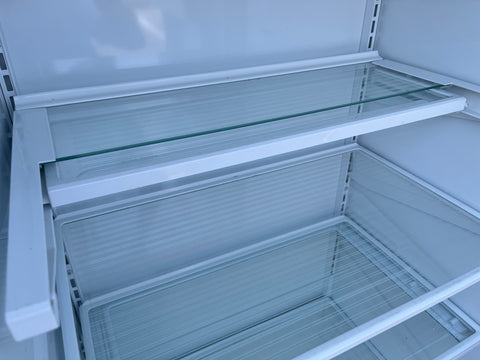 Close-up view of interior of GE ZISB42DCA in-wall refrigerator showing unique retractable Quick Space shelf. 