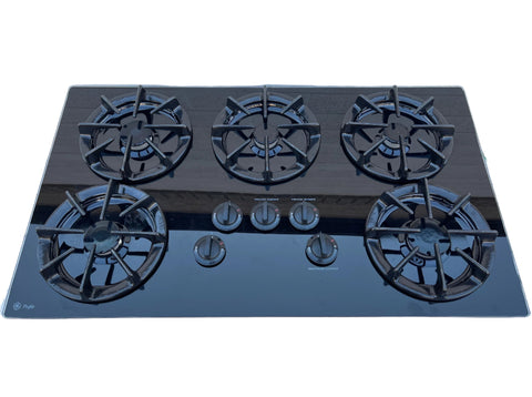 Overview of reclaimed G.E. Profile 36" glass cooktop, model # JGP636BEV3BB with 5 gas burners and simple control knobs. 