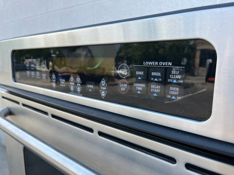 Detail of digital display and electronic control panel on GE model #JTP50S0H2SS in-wall double electric oven. 