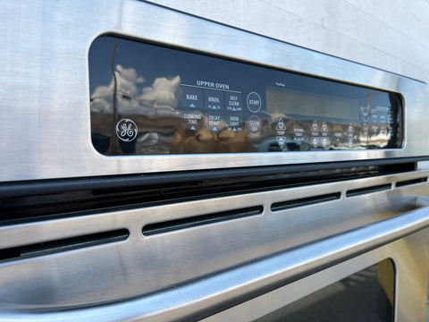 Close-up of GE 30" double oven control panel featuring soft-touch electronic controls. 