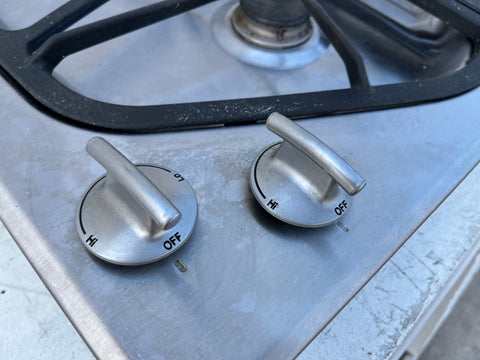 Detail of knob controls on JennAir #JGD8536ADS stainless steel cooktop. 