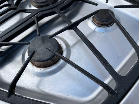 Detail of right side grates and burners with electronic ignition on Jenn-Air 36" gas cooktop. 