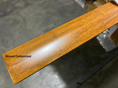 Overview of solid wood floor reducer with strand carbonized finish. 