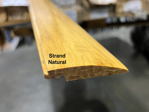 End detail of new, strand natural finish, solid wood floor reducer. 