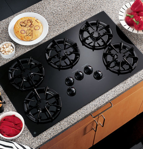 Stock image of General Electric 36" glass top, gas cooktop with 5 burners. 