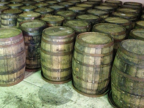 View of dozens of reclaimed oak whiskey barrels. Material Resourcers repurposes materials from industrial & manufacturing companies. Bring us your waste, excess, non-recyclable, by-product, remnant, blemished, cancelled, and expired materials.