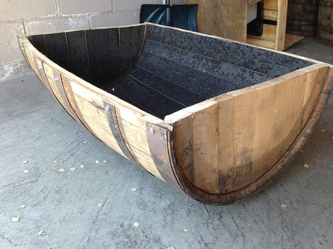 Side view of cradle-cut whiskey barrel. Material Resourcers repurposes materials from industrial & manufacturing companies. Bring us your waste, excess, non-recyclable, by-product, remnant, blemished, cancelled, and expired materials.